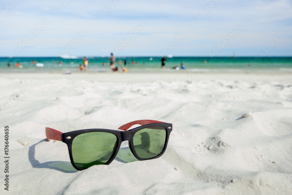 Sunglasses are placed on the beach.