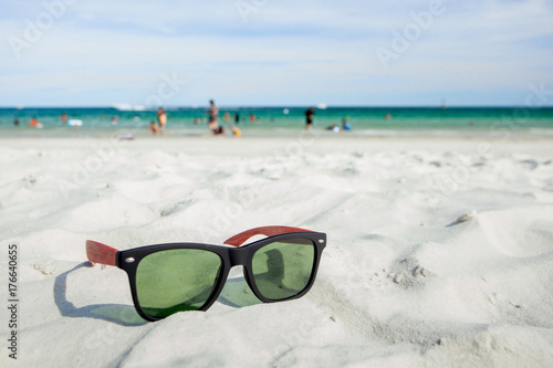Sunglasses are placed on the beach.
