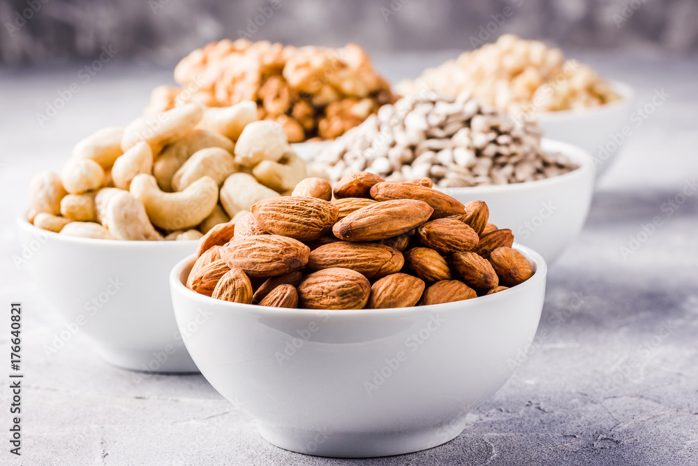 Nuts assortment, sunflower seeds, pine nuts, cashew,walnut,almond. Selective focus,space for text. Nuts assortment, sunflower seeds, pine nuts, cashew,walnut,almond. Selective focus,space for text.