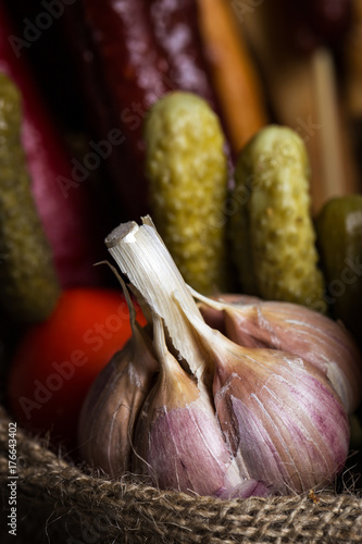 Garlic. Garlic on the bag. In the background vegetables. photo