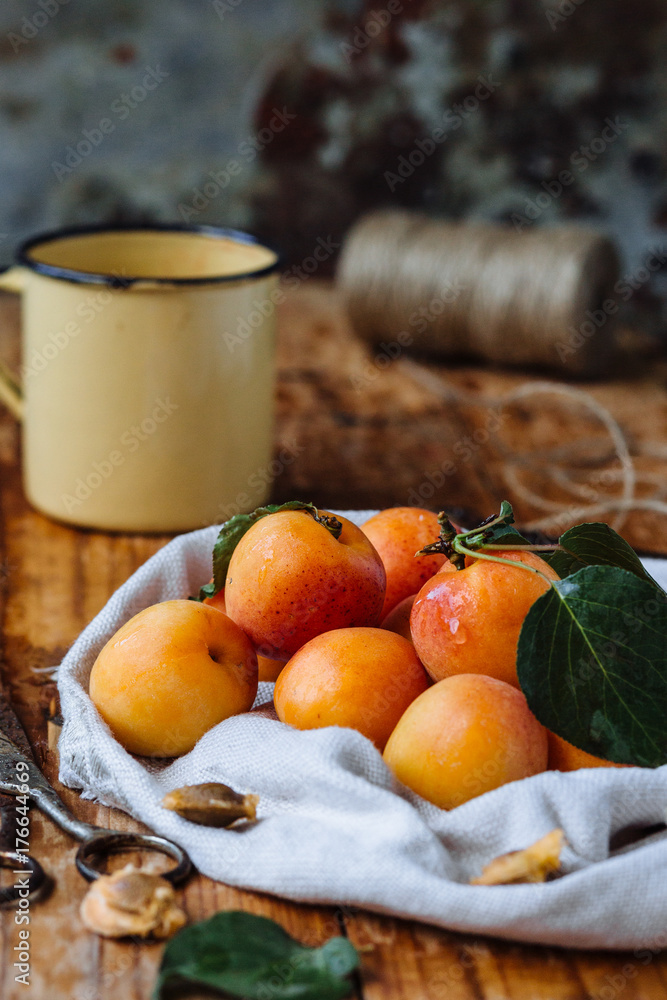 Delicious ripe apricots in a wooden bowl on the table close-up. Horizontal view from above Delicious ripe apricots in a wooden bowl on the table close-up. Horizontal view from above
