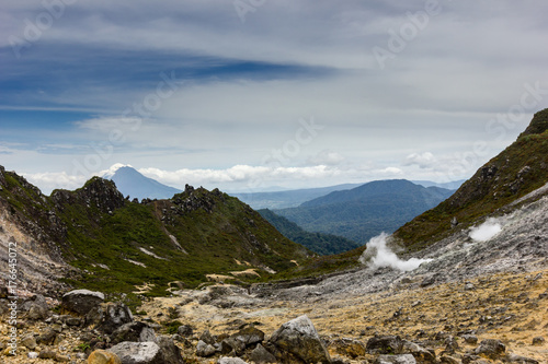 Fototapeta Naklejka Na Ścianę i Meble -  Volcanic fumaroles emitting Sulphur and steam on a bleak high volcano (Mount Sibayak)