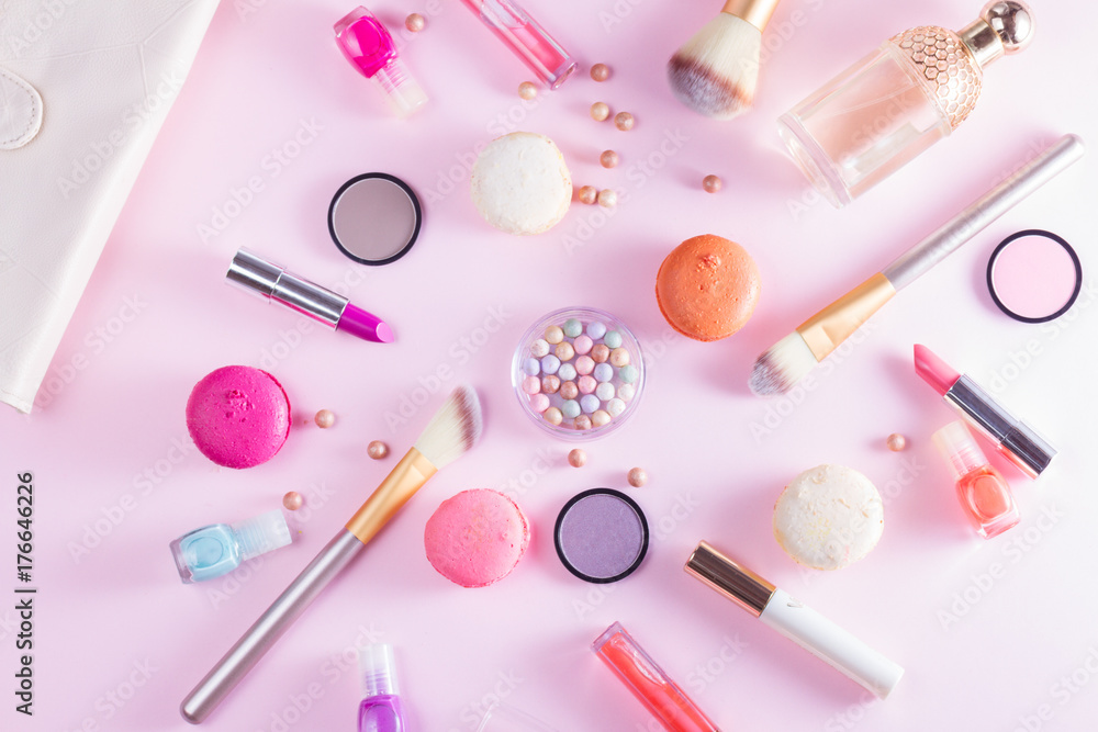 Make up products and macaroons on pink background Make up products and macaroons on pink background