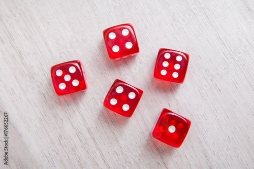 Red dices on a wooden background