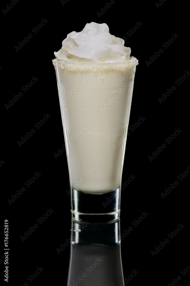 Coconut cream and rum cocktail in highball glass isolated. Pina colada drink. Coconut cream and rum cocktail in highball glass isolated. Pina colada drink.