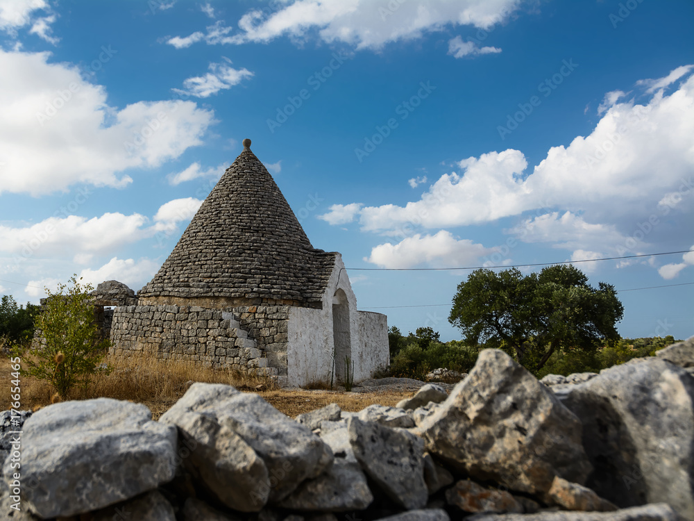 country trulli with clouds in the sky