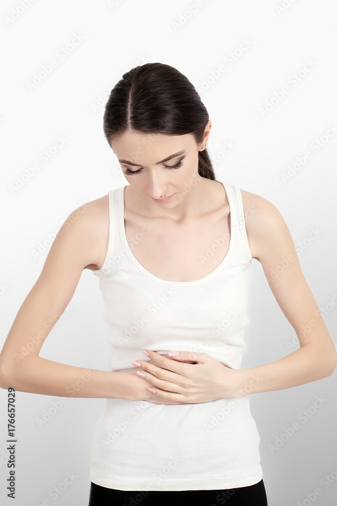 Woman is feeling pain in lower part of her stomach Woman is feeling pain in lower part of her stomach