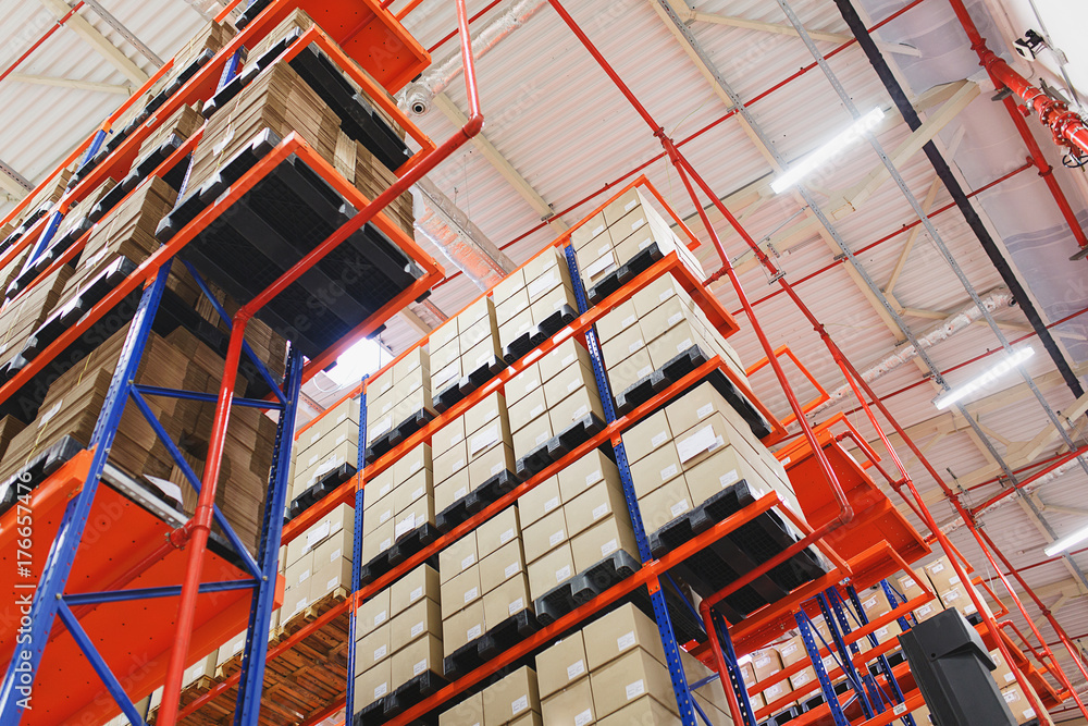 Warehouse address storage of goods and materials on shelves in large cardboard boxes. Warehouse address storage of goods and materials on shelves in large cardboard boxes.