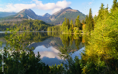 Mountain lake Strbske pleso in National Park High Tatra, Slovakia, Europe. Ski resort in summer and autumn time. Peaceful nature wallpaper. Tranquil vacations travel concept. © prystai