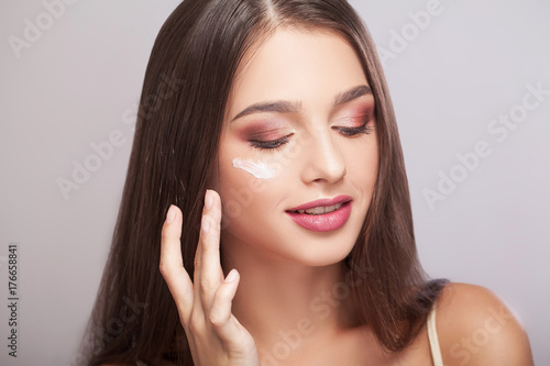 Close-up of a Young Woman Getting Spa Treatment. Cosmetic Cream on a Cheek. Skin Care