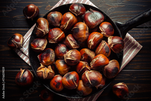 chestnuts in a pan on dark wooden background
