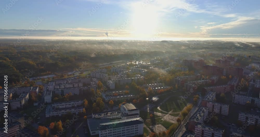Beautiful Aerial Shot of Misty Sunrise in small town. Colorful clouds, fog above the city. Camera tit up. Beautiful Aerial Shot of Misty Sunrise in small town. Colorful clouds, fog above the city. Camera tit up.