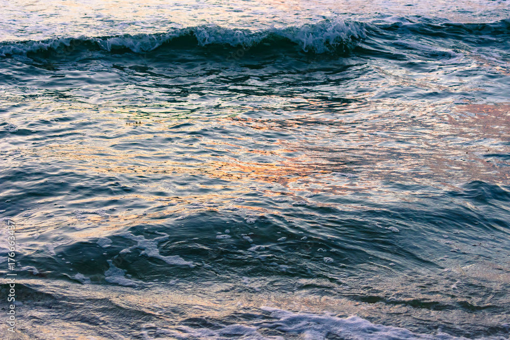 Fototapeta premium background texture - waves reflecting colors from the morning sky