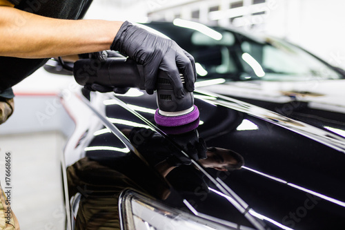 Car detailing - Hand with orbital polisher in auto repair shop.  © hedgehog94