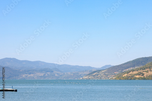 Birds flying over Danube river in the Iron Gates, also known as Djerdap, which are the Danube gorges, a natural symbol of the border between Serbia and Romania..