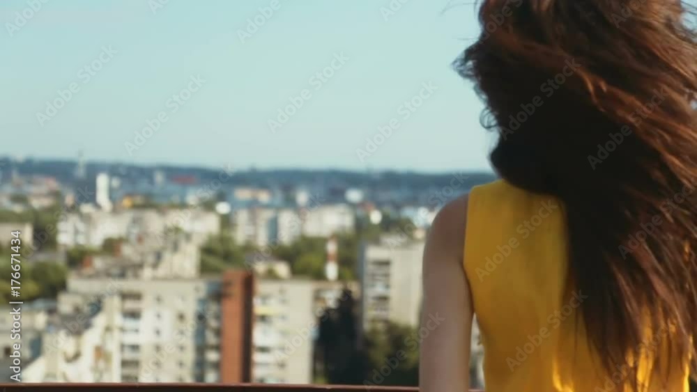 Beautiful brunette young model woman girl yellow dress turning around back sun light smiling looking camera happy whirling glow sun free happy art warm amazing city view urban buildings background Beautiful brunette young model woman girl yellow dress turning around back sun light smiling looking camera happy whirling glow sun free happy art warm amazing city view urban buildings background