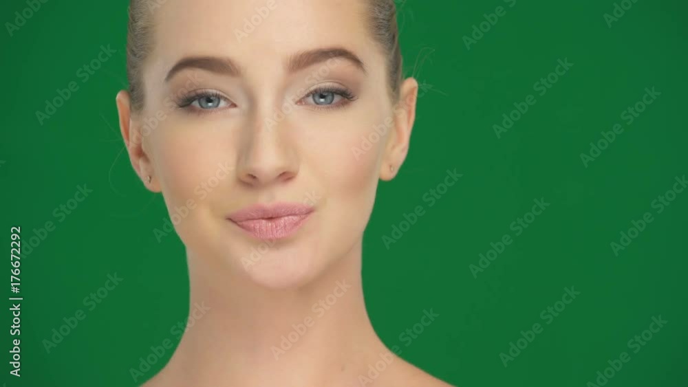 Beautiful girl applies cosmetics on the face with a makeup sponge Beautiful girl applies cosmetics on the face with a makeup sponge