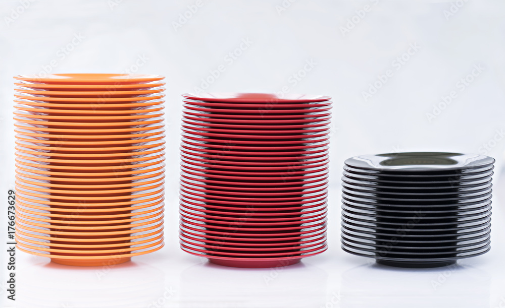Melamine Black/Red/Orange Plate stack on white background Melamine Black/Red/Orange Plate stack on white background