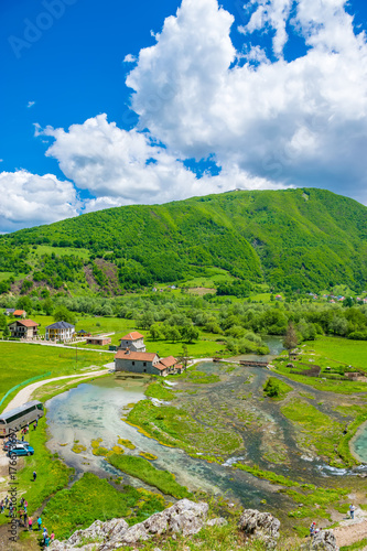 MONTENEGRO, GUSINJE - MAY 29/2017: a group of tourists visit the famous sources of Ali Pasha near the Prokletije mountains. photo