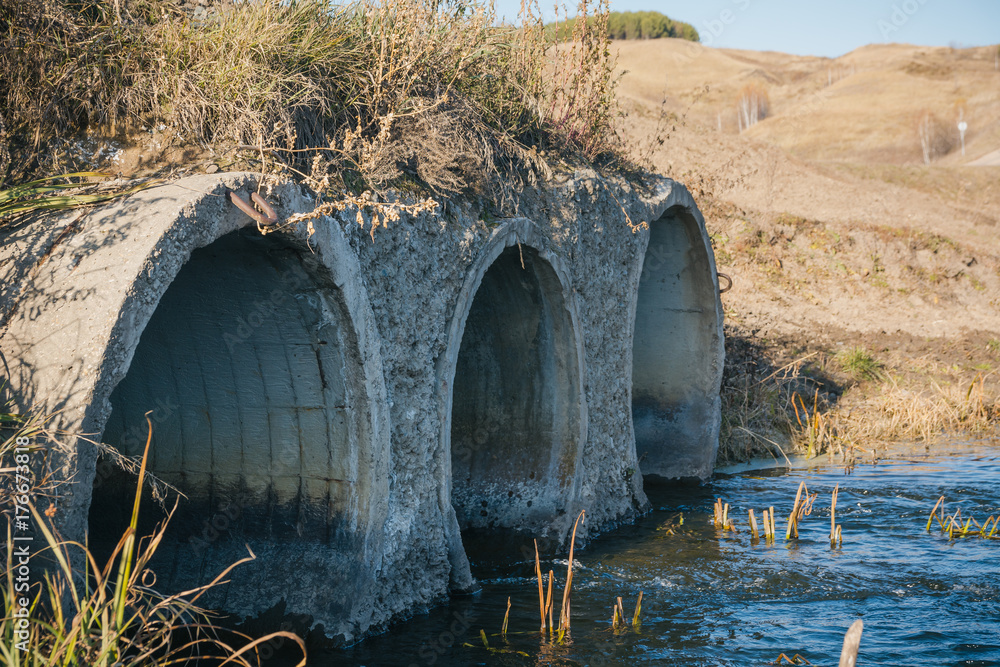 Pipes under the road from which water runs. Pipes under the road from which water runs.