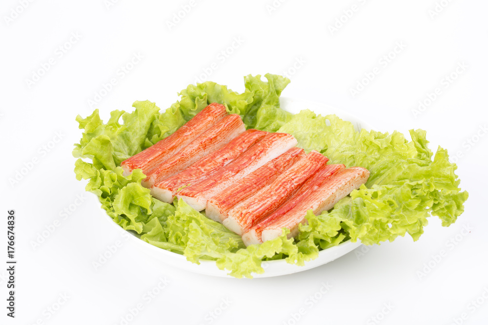 Red crab stick with green lettuce in a white plate. Red crab stick with green lettuce in a white plate.