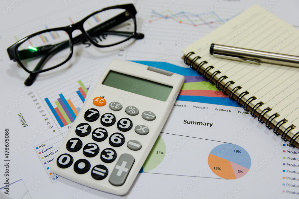 Office Concepts : data analyzing with calculator,glasses,notebook and pen. on charts and graph to find out the result. Office Concepts : data analyzing with calculator,glasses,notebook and pen. on charts and graph to find out the result.