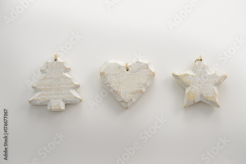 Festive Christmas decoration with wooden star, Christmas tree and heart with copyspace on white