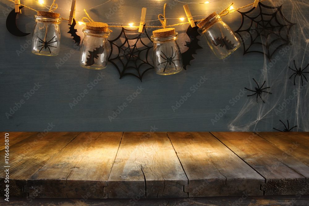 Fototapeta premium Halloween holiday background with empty rustic table. Ready for product display montage