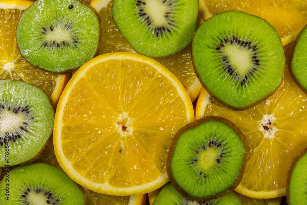Sliced kiwi fruits and oranges for background Sliced kiwi fruits and oranges for background