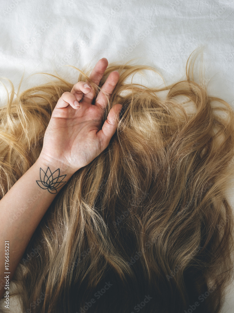 Obraz premium Woman with Brunette Hair Lying Down on the Bed