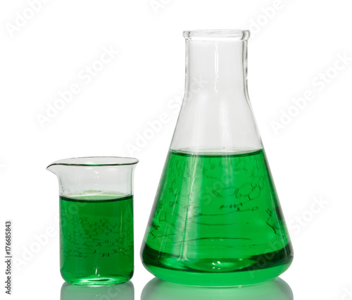 A chemical flask, beaker with green liquids and sheet of paper with formulas isolated on white background.