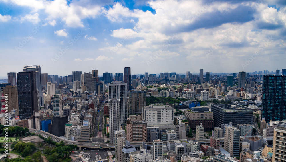Fototapeta premium Beautiful city skyline of Downtown Tokyo, Among crowded skyscrapers under blue sunny sky in Tokyo, Japan. Aerial view of busy Tokyo City. 10 October 2017