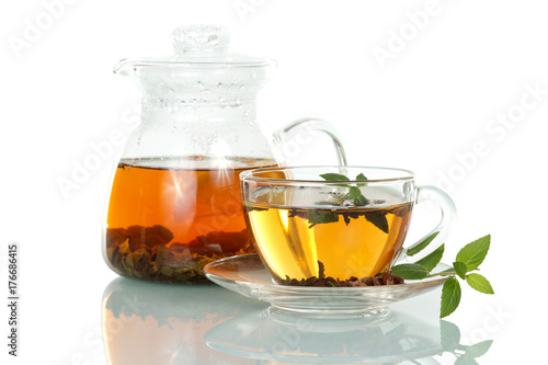 Cup of hot tea with mint and jug isolated on white background