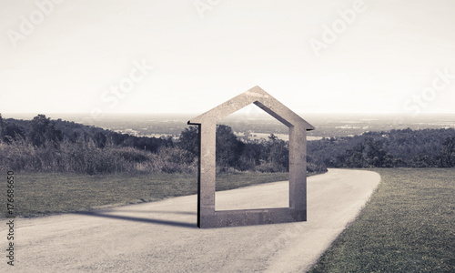 Conceptual background image of concrete home sign on asphalt roa