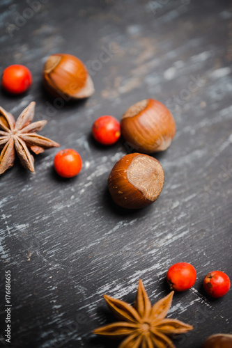 Autumn decorations with spices and leaves on the rustic background. Shallow depth of field.