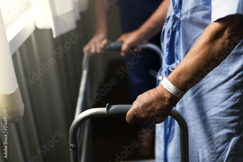 An elderly man using a walker