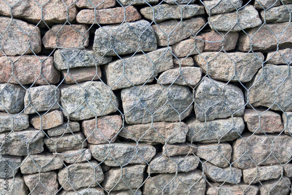 Stones in steel mesh cage (background, texture, abstract) Stones in steel mesh cage (background, texture, abstract)