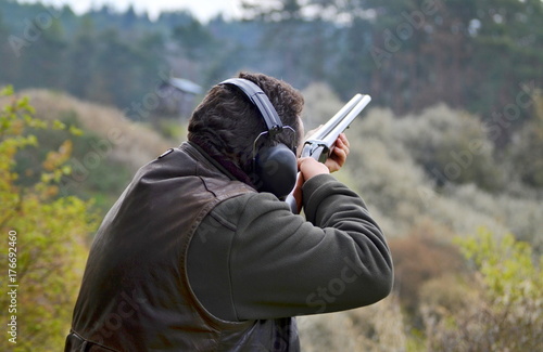 shooter aiming at the asphalt pigeon
