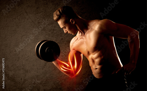 Fit bodybuilder lifting weight with red muscle concept