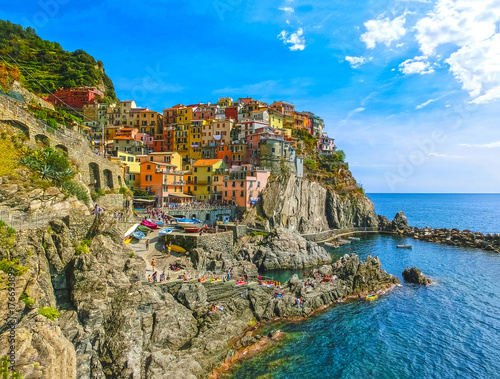 Colorful traditional houses on a rock over Mediterranean sea, Manarola, Cinque Terre, Italy photo