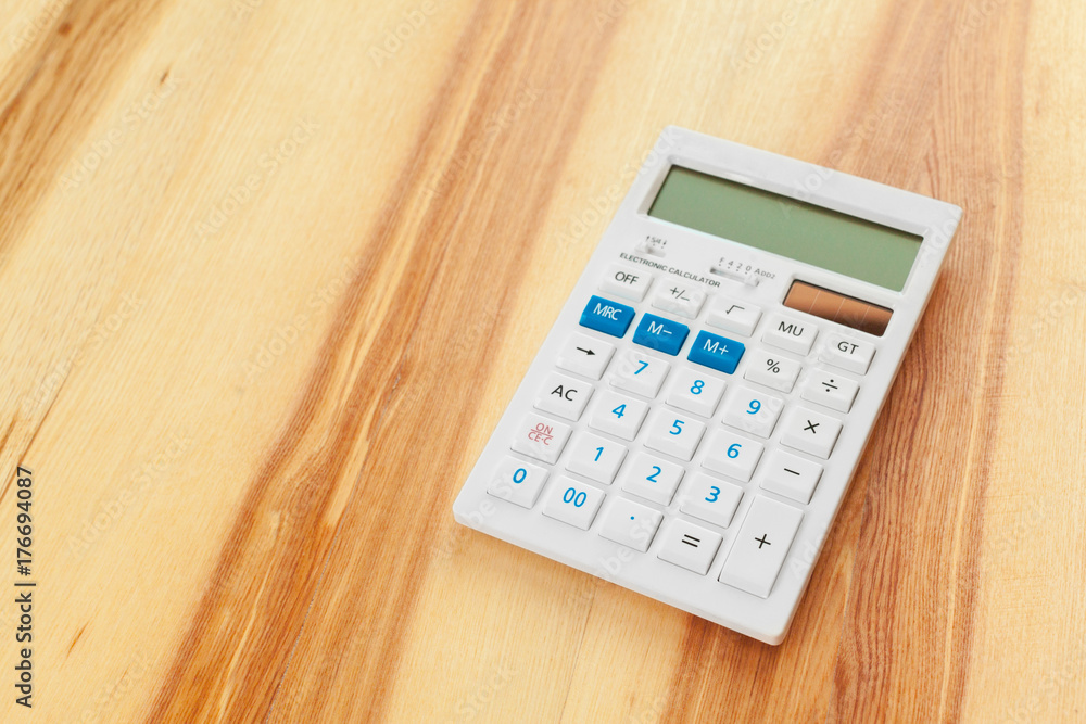 calculator on a wooden background calculator on a wooden background