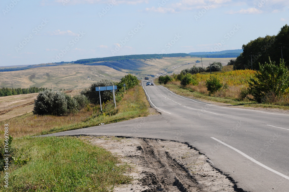 Country summer landscape with a road. Hitch-hiking on the roadside Country summer landscape with a road. Hitch-hiking on the roadside