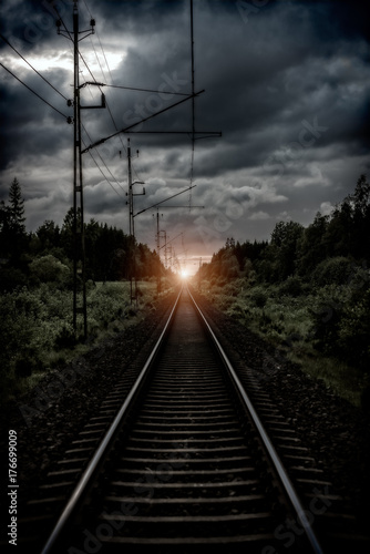 railroad tracks and a dramatic sky