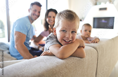 Smiling kids with their parents in the living room