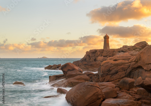 The beautiful lighthouse Phare Mean Ruz on the cote granite rose coast in Ploumanch, Brittany