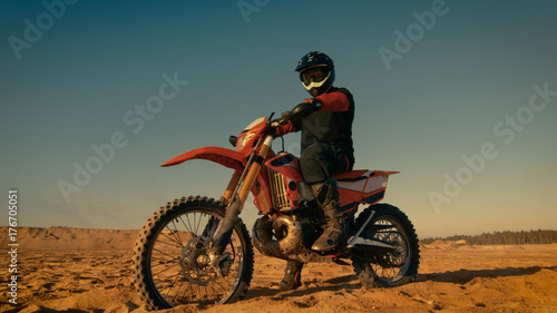 Shot of the Professional Motocross Driver Sitting on His FMX Dirt Bike.