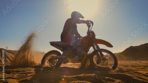 Professional Motocross FMX Motorcycle Rider Drives in Circles on the Off-Road Deserted Quarry.