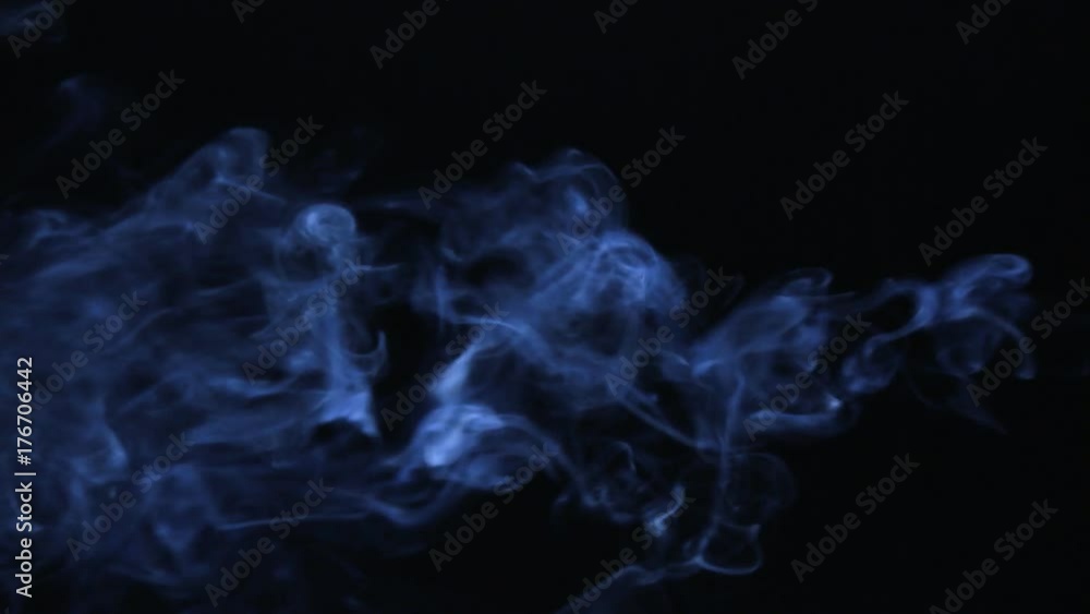 Clubs of blue smoke on a black background. Beautiful Clubs of blue smoke on a black background. Beautiful