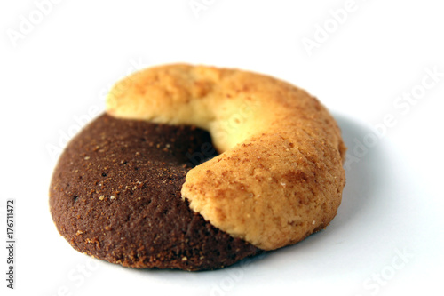 Rounded cookie with half brown chocolate and half light cream side view