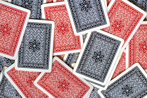 Texture of red and blue playing cards back spread on a table